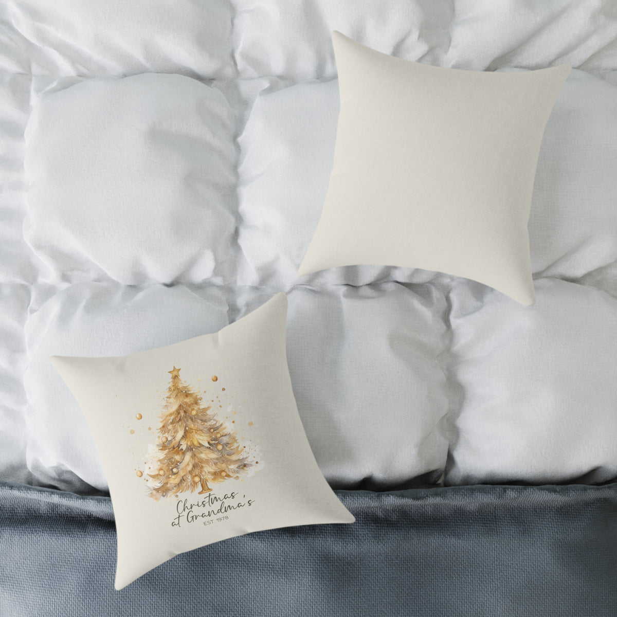 Front and back of the personalized Christmas at Grandma's gold tree pillow on a white bed