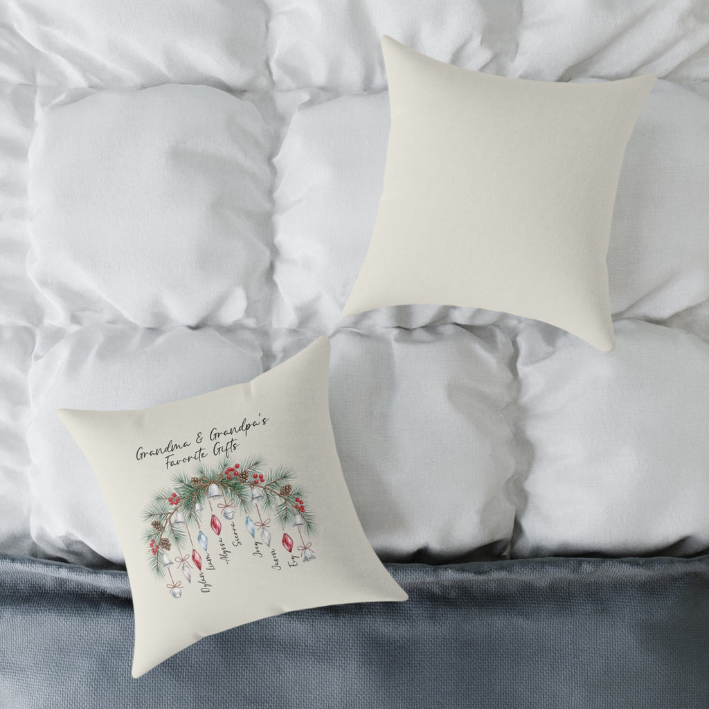 Front and back of the personalized Grandma and Grandpa's Favorite Gifts ornament pillow on a white bed