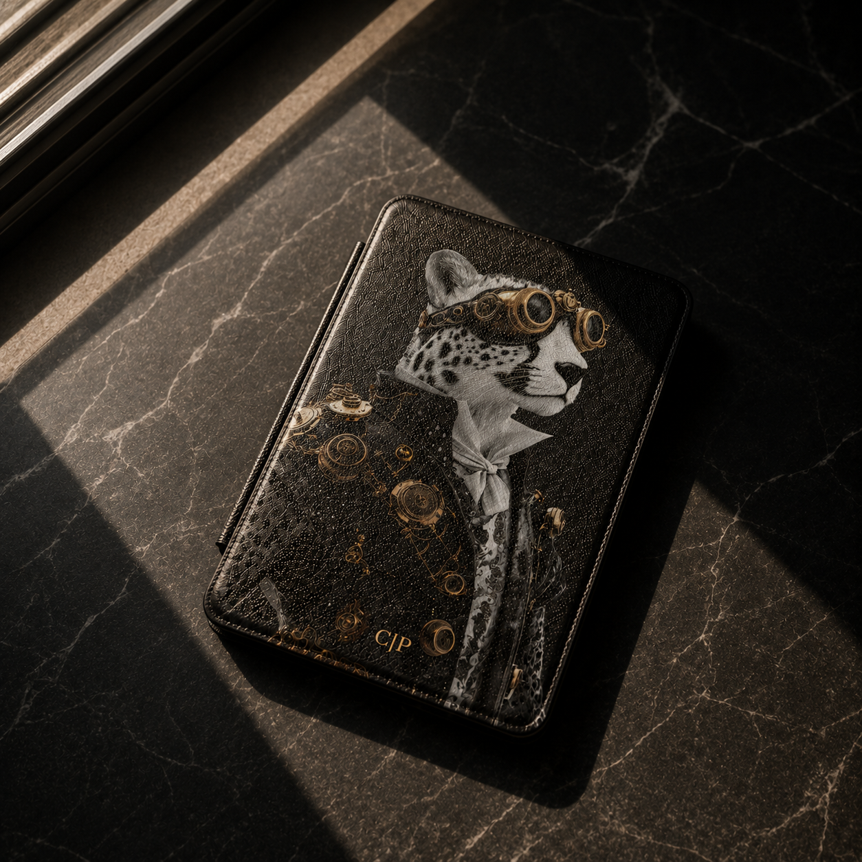 A black textured leather kindle case with a stylized white and gold leopard illustration, photographed on a dark marble surface with dramatic sunlight and shadows.