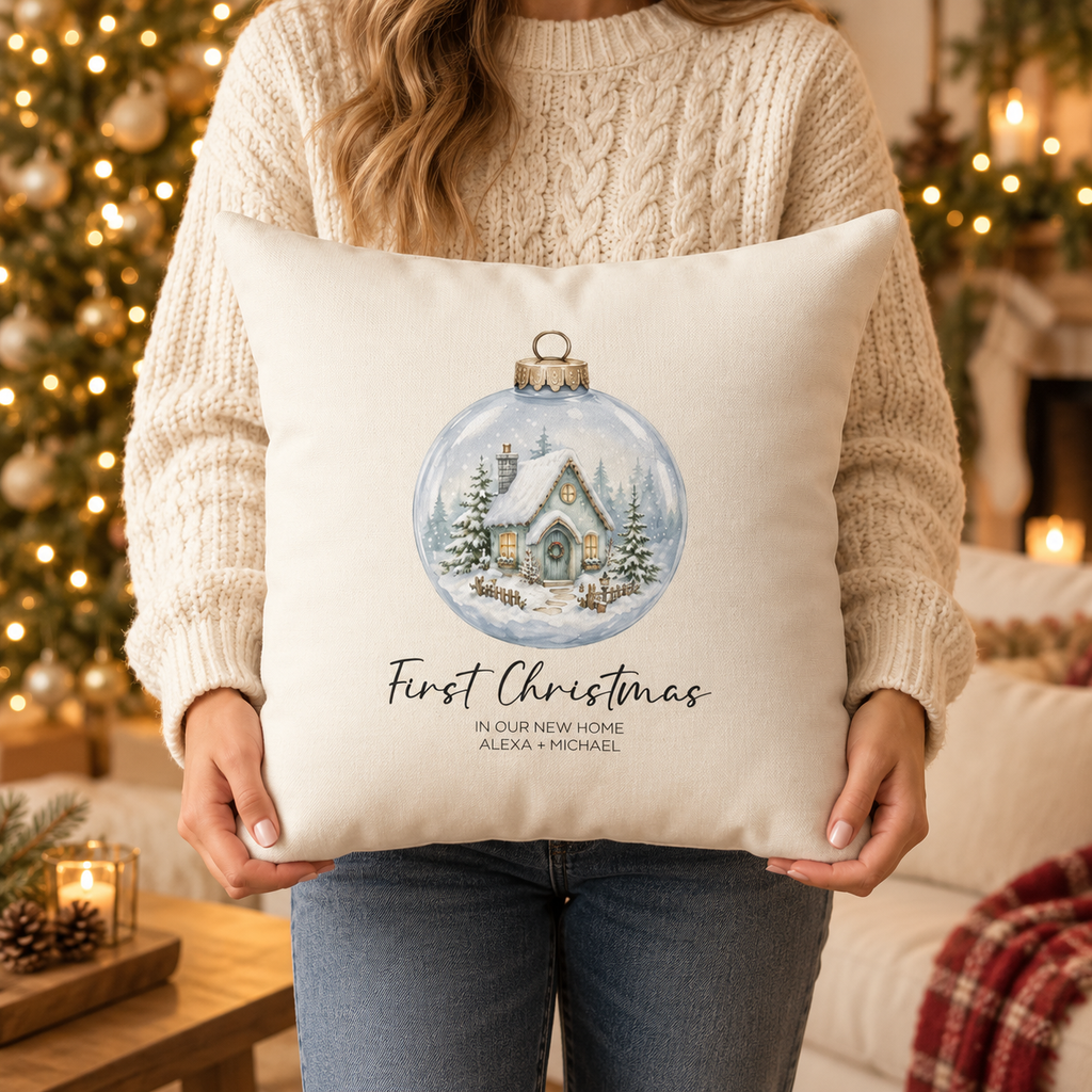 Person holding the personalized first Christmas in our new home snow globe pillow