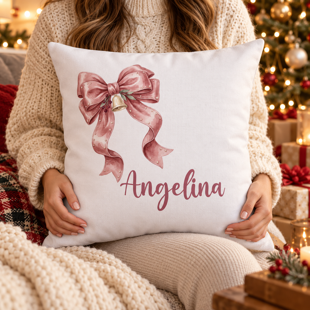 Person holding the personalized pink ribbon bow name pillow