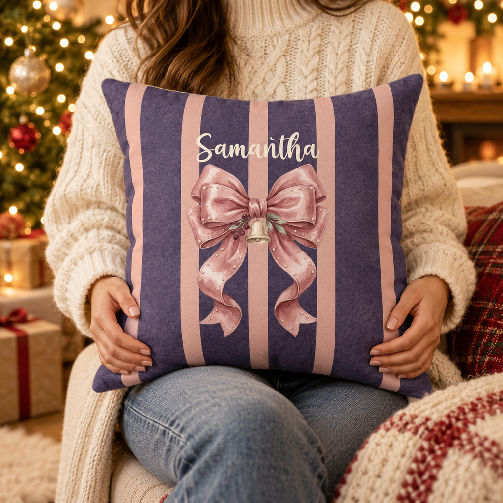 Person holding the personalized pink bow name pillow on plum stripes