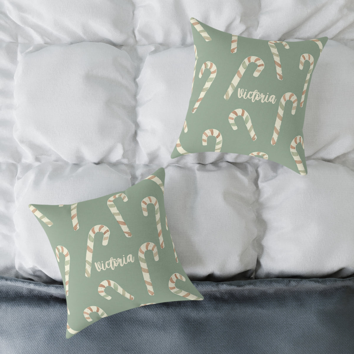 Front and back of the personalized candy cane name pillow on a white bed