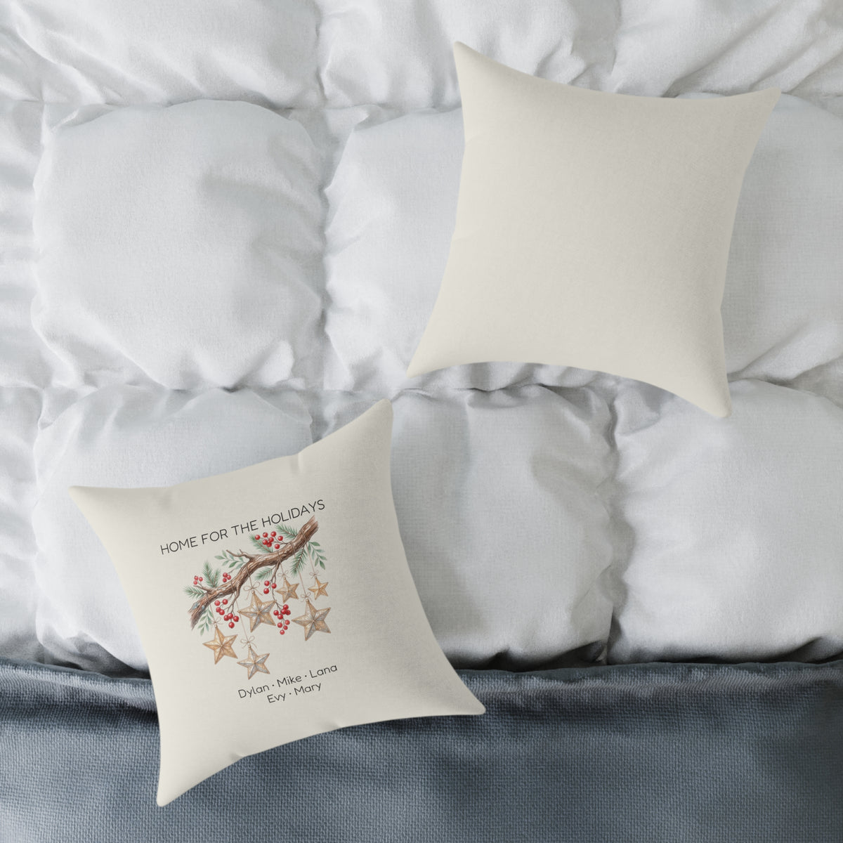 Front and back of the personalized Home for the Holidays wooden stars pillow on a white bed