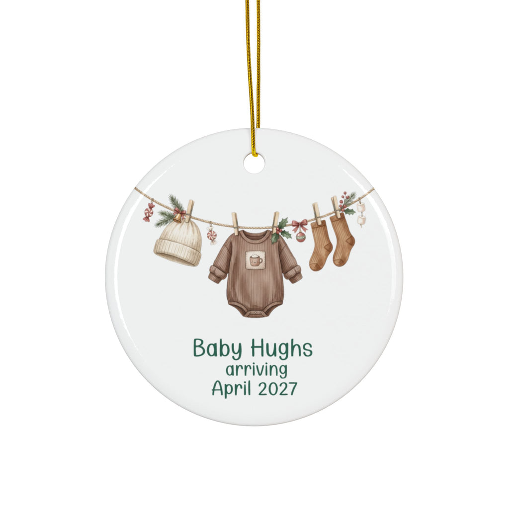 Personalized gender neutral baby arriving Christmas ornament with brown bodysuit, knit hat and socks on a garland, family name and due date