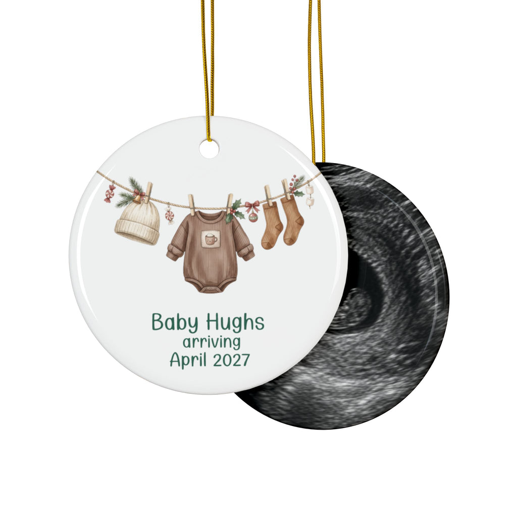 Double-sided gender neutral baby arriving ornament with brown bodysuit, knit hat and socks on the front and an ultrasound photo on the back