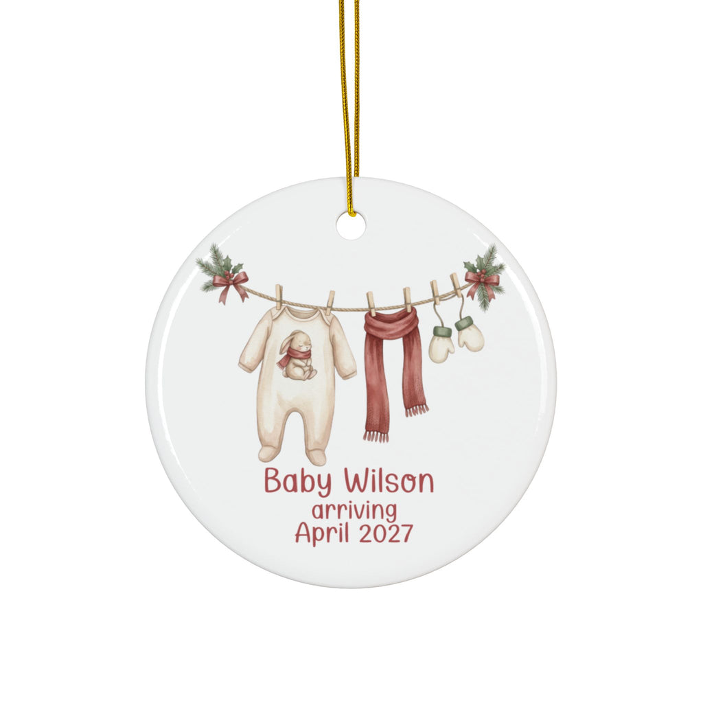 Personalized baby arriving Christmas ornament with bunny sleeper, red scarf and mittens on a clothesline, family name and due date