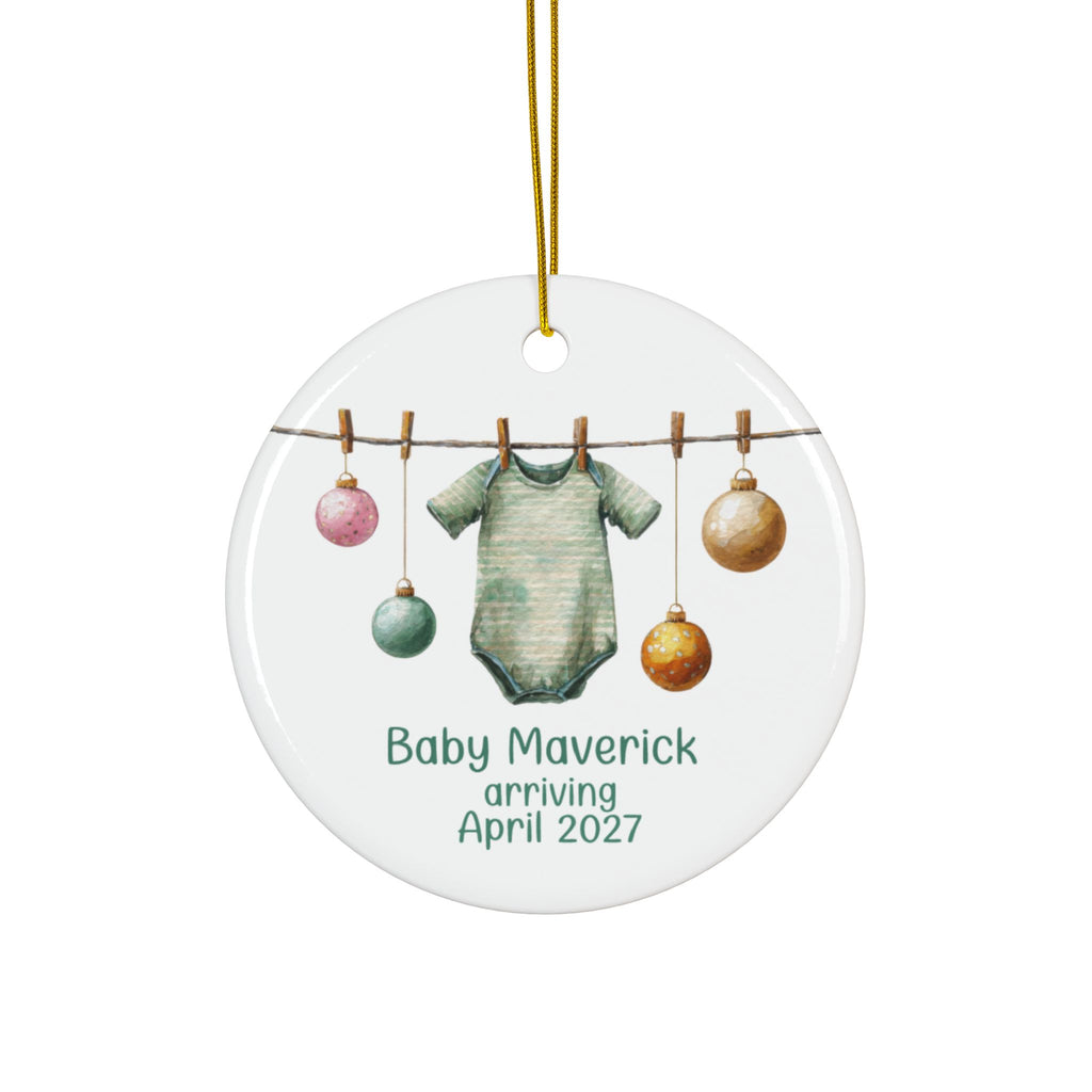 Personalized baby arriving Christmas ornament with sage green striped bodysuit and baubles on a clothesline, family name and due date