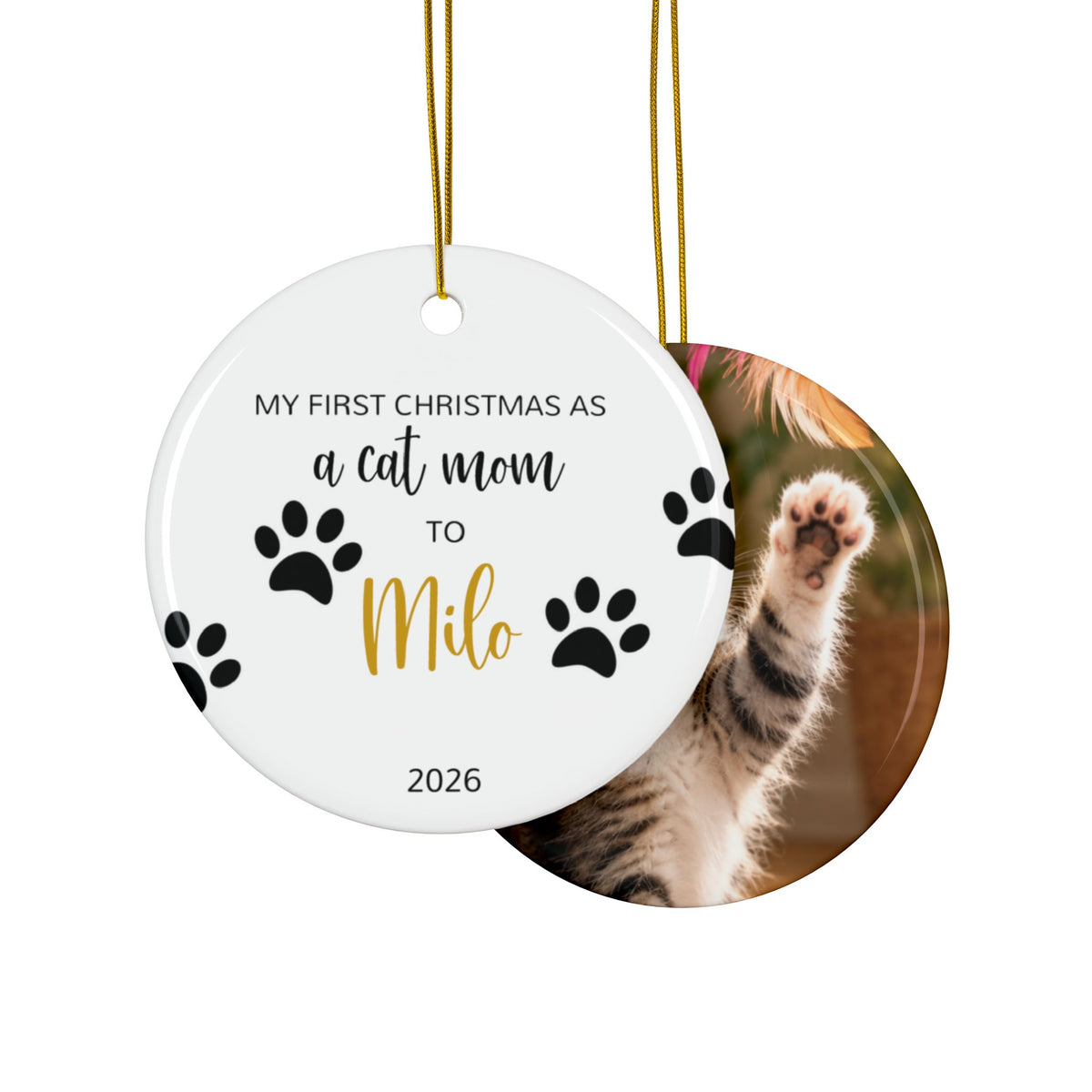 Front and back of the personalized cat mom first Christmas ornament with paw prints and gold script name, design and photo side