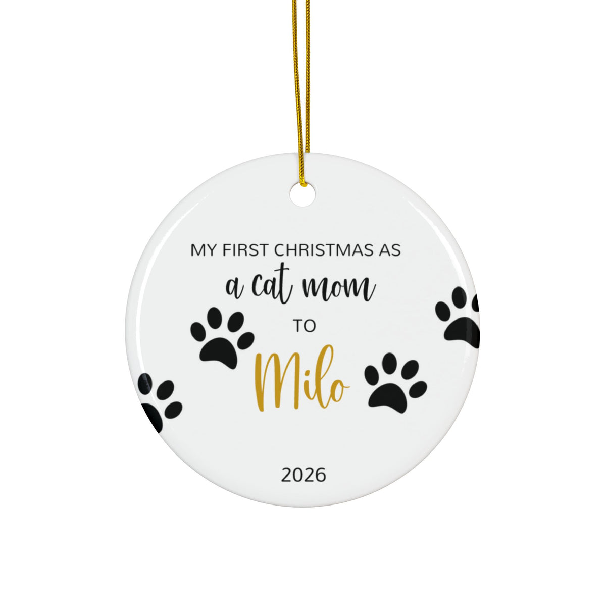Personalized cat mom first Christmas ornament with paw prints and gold script name, front side