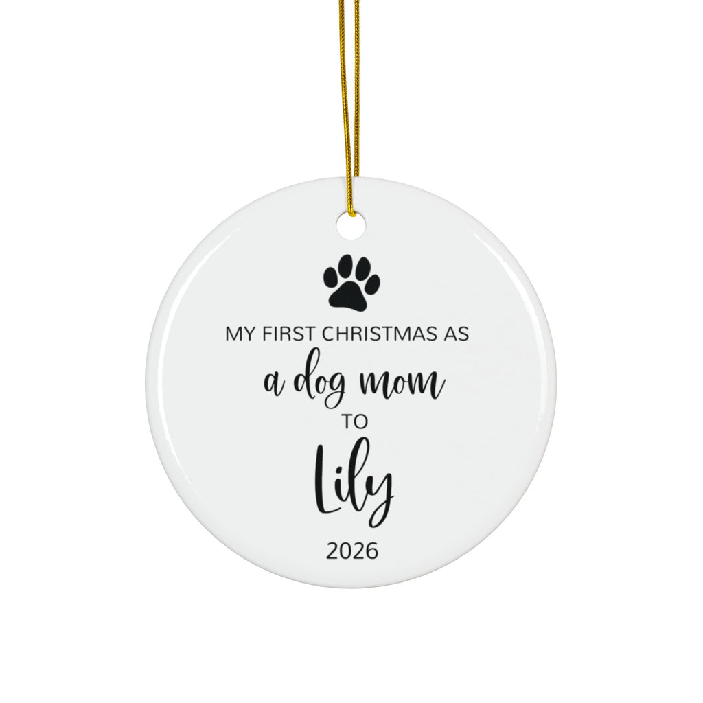 Personalized dog mom first Christmas ornament with paw print and black script name, front side