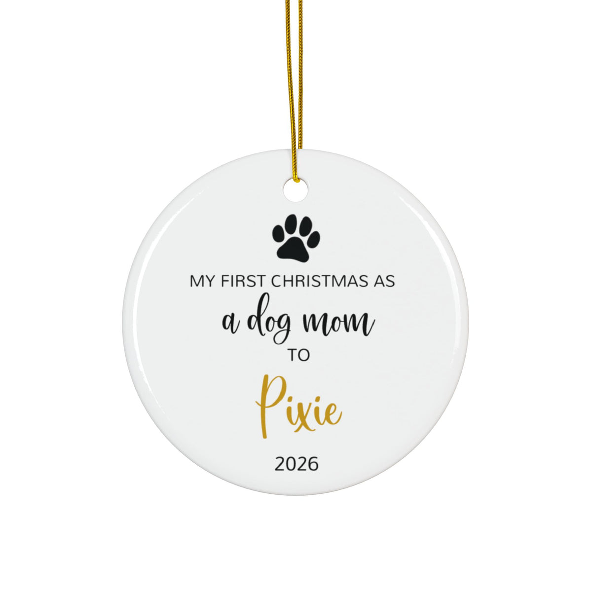 Personalized dog mom first Christmas ornament with paw print and gold script name, front side