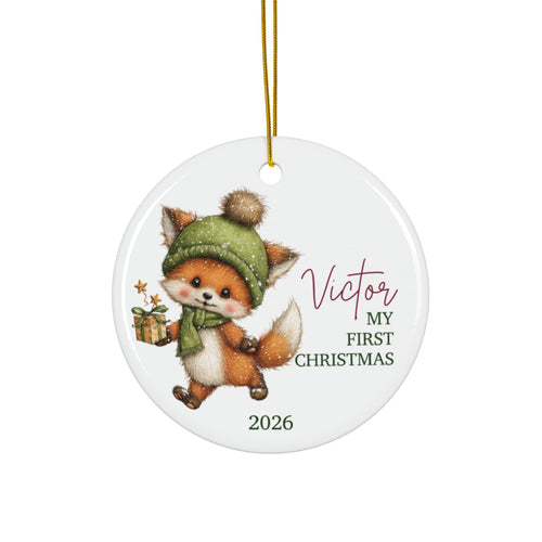Personalized baby's first Christmas ornament with a fox in a green knit hat carrying a gift, baby name and 2026