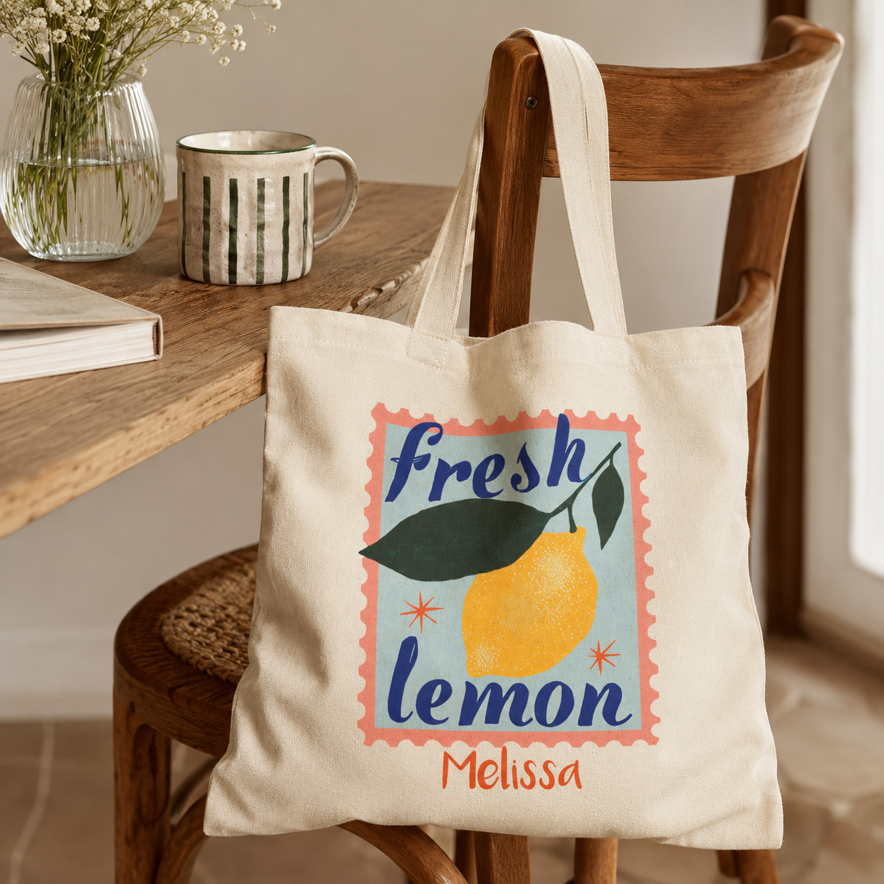 Close-up of fresh lemon stamp print and custom name on canvas tote bag