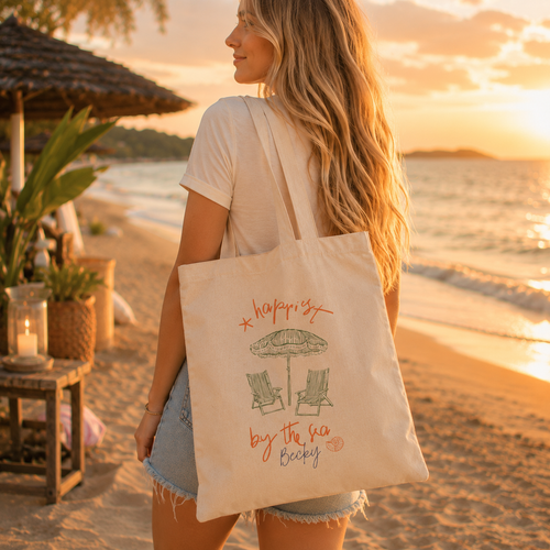 Personalized happiest by the sea tote bag shown worn on shoulder, lifestyle photo