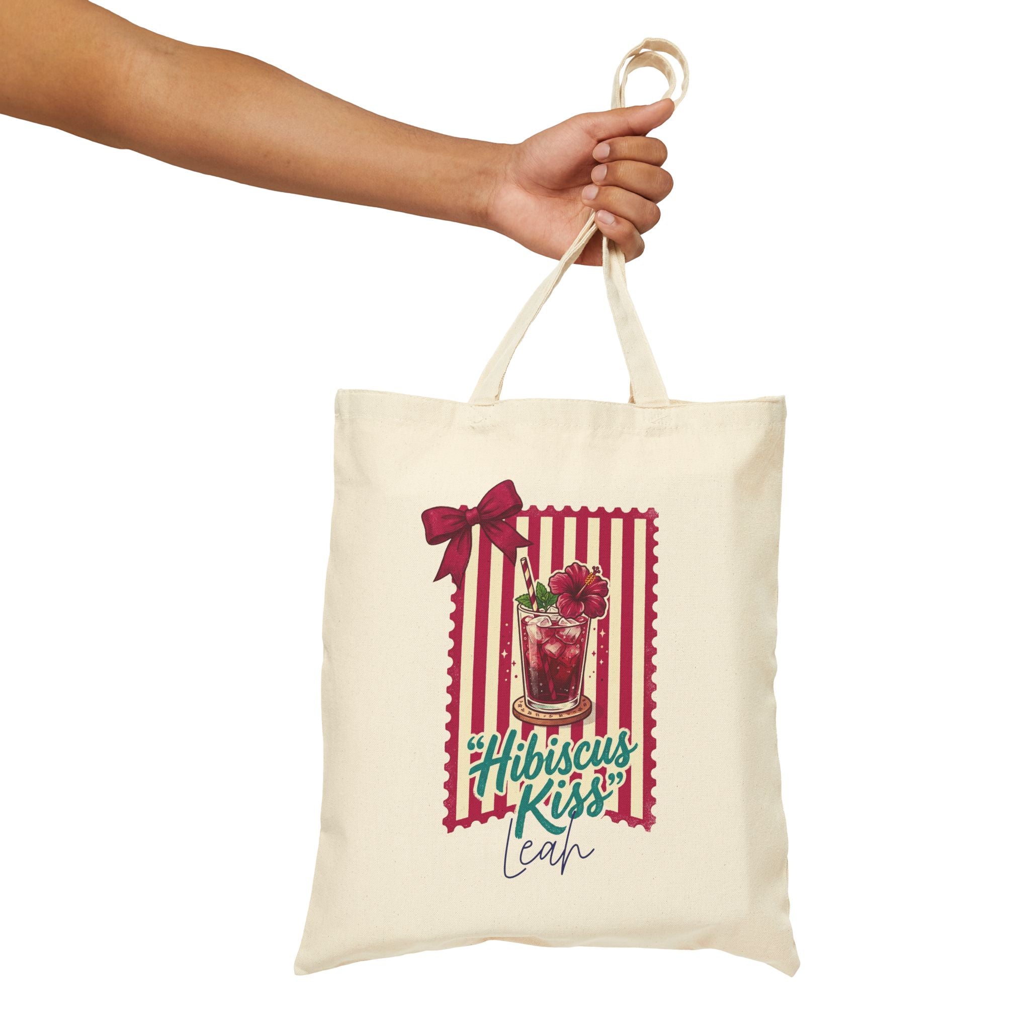 Personalized hibiscus kiss canvas tote bag styled in a home setting