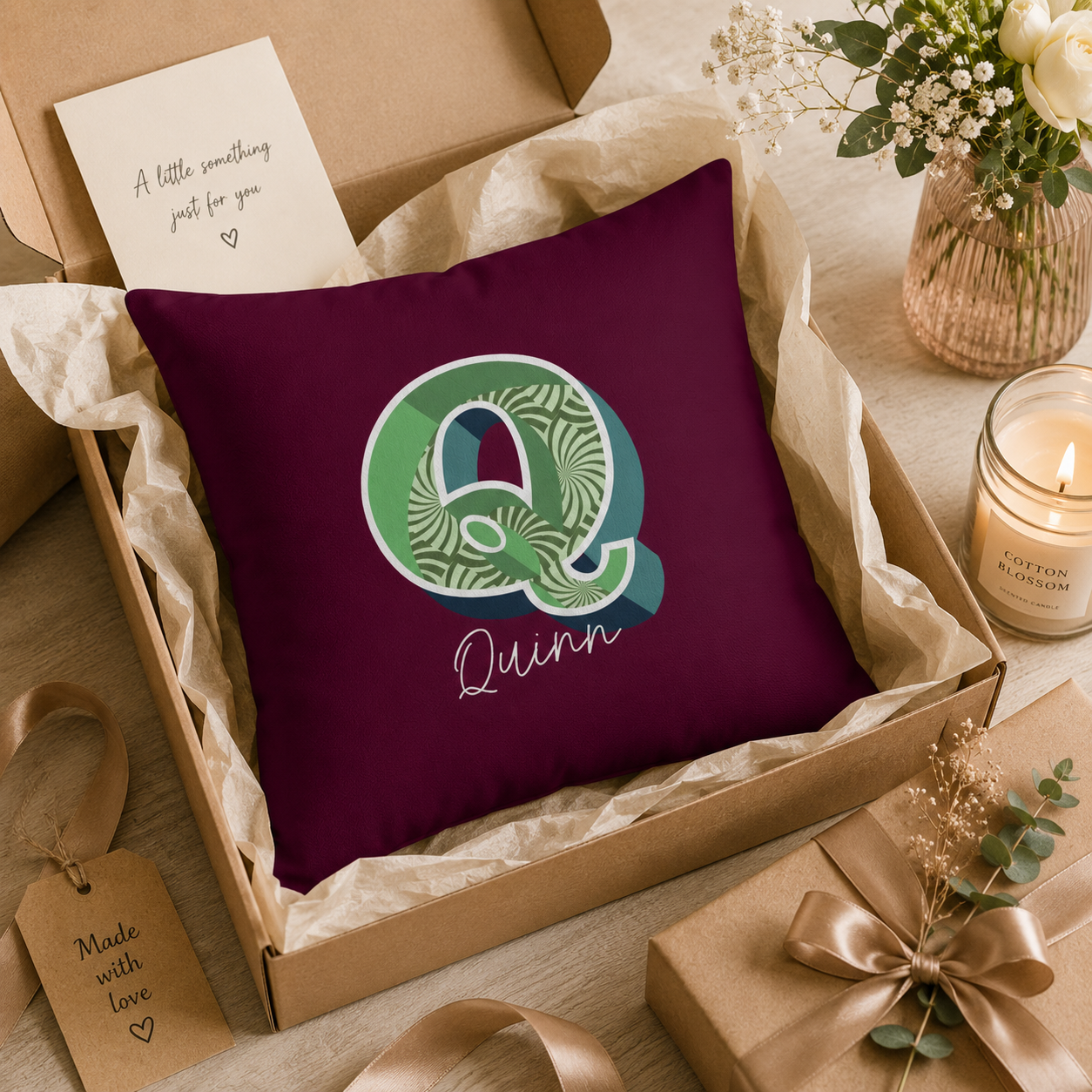 Close-up of retro Q initial with burgundy and teal pattern detail