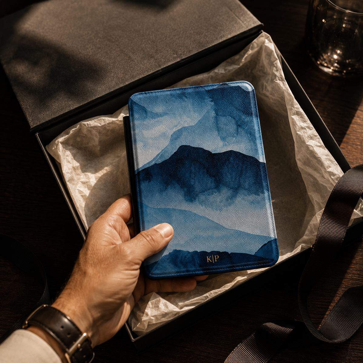 Open interior of the blue watercolor mountain Kindle case showing the fabric lining and TPU shell