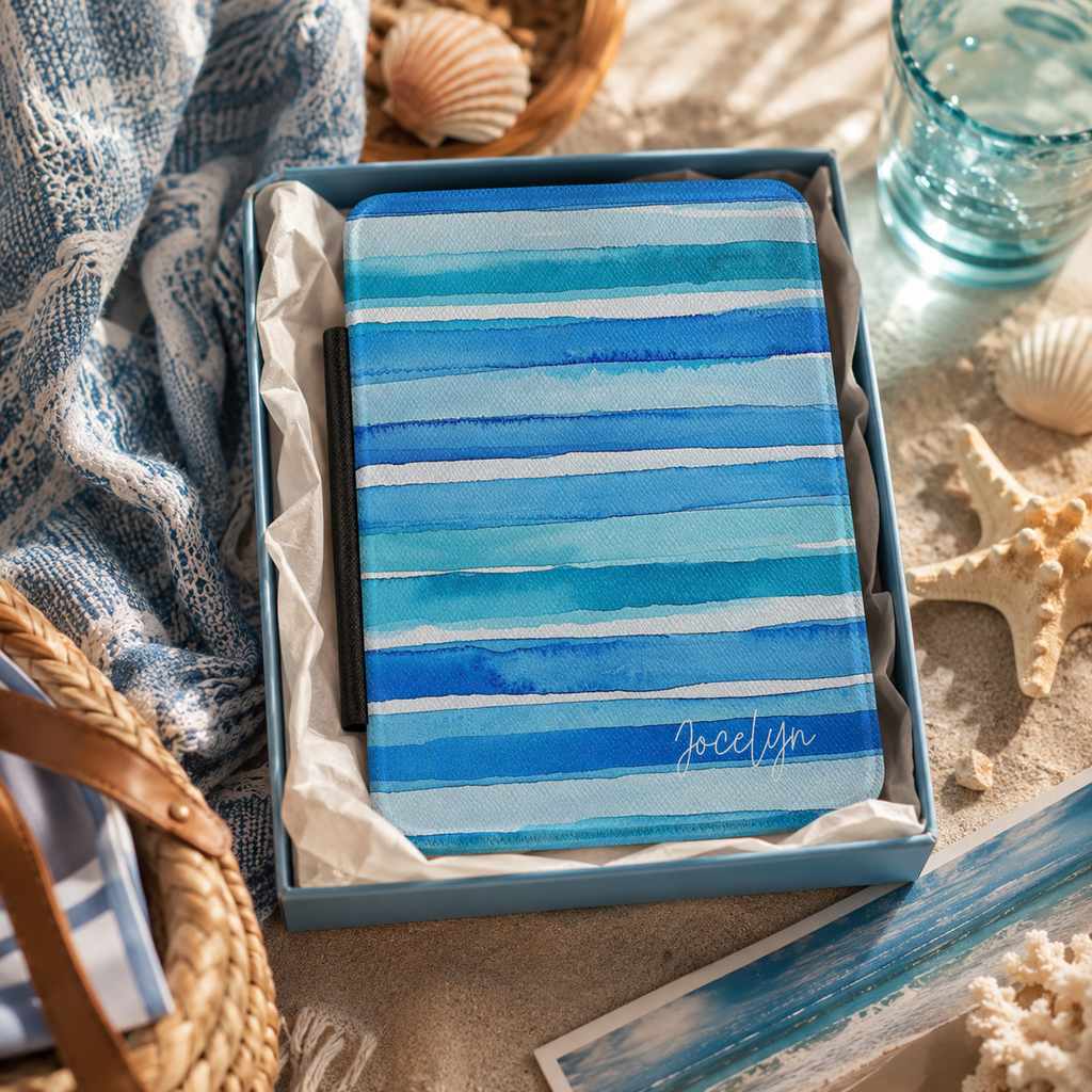 Personalized blue watercolor stripes horizontal Kindle case shown in a gift setting