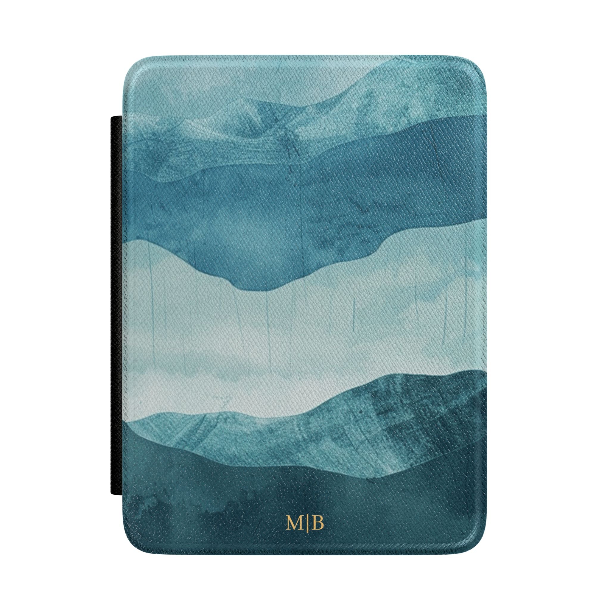 Layered blue watercolor mountain personalized Kindle case with gold initials, front view