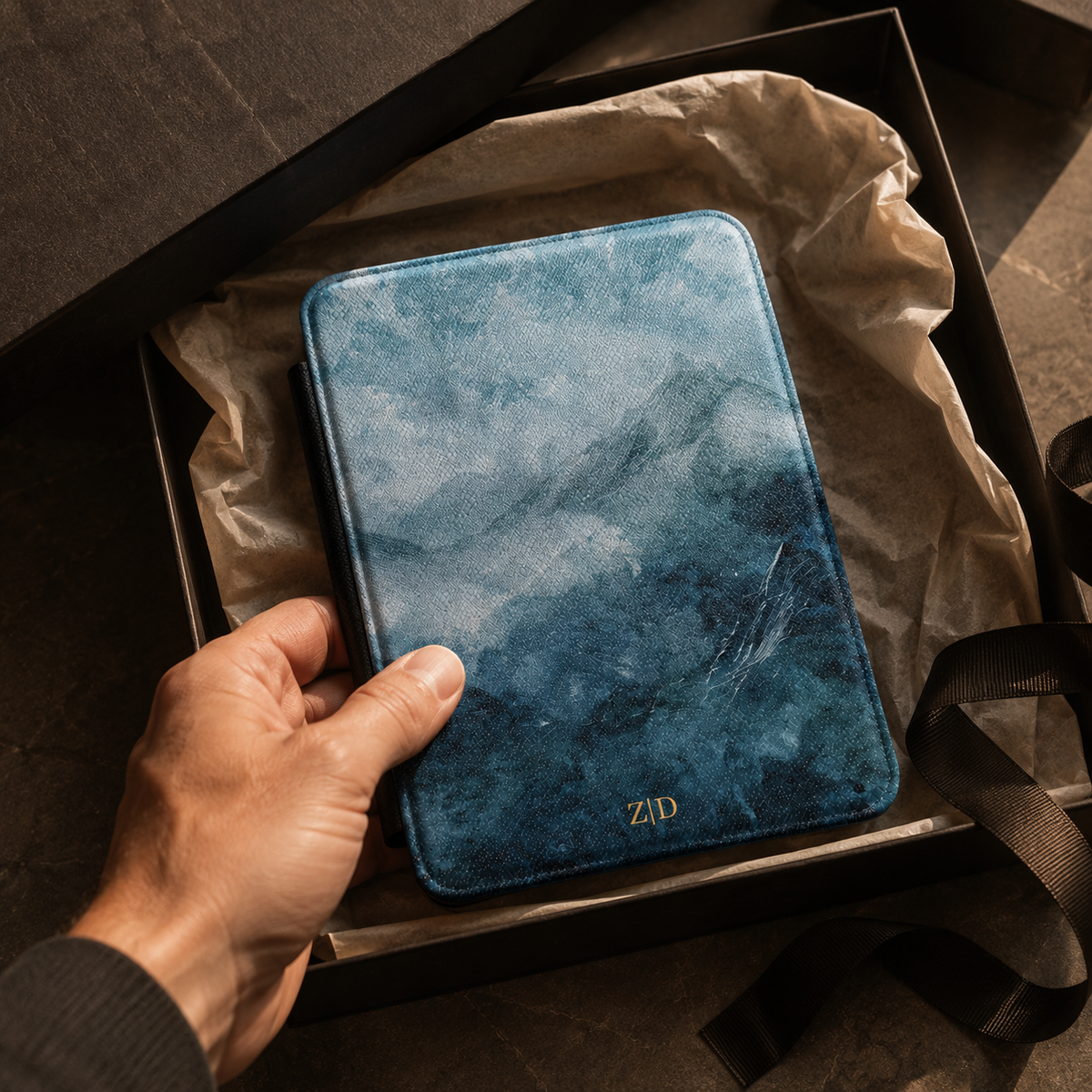 Open interior of the misty blue mountain Kindle case showing the fabric lining and TPU shell