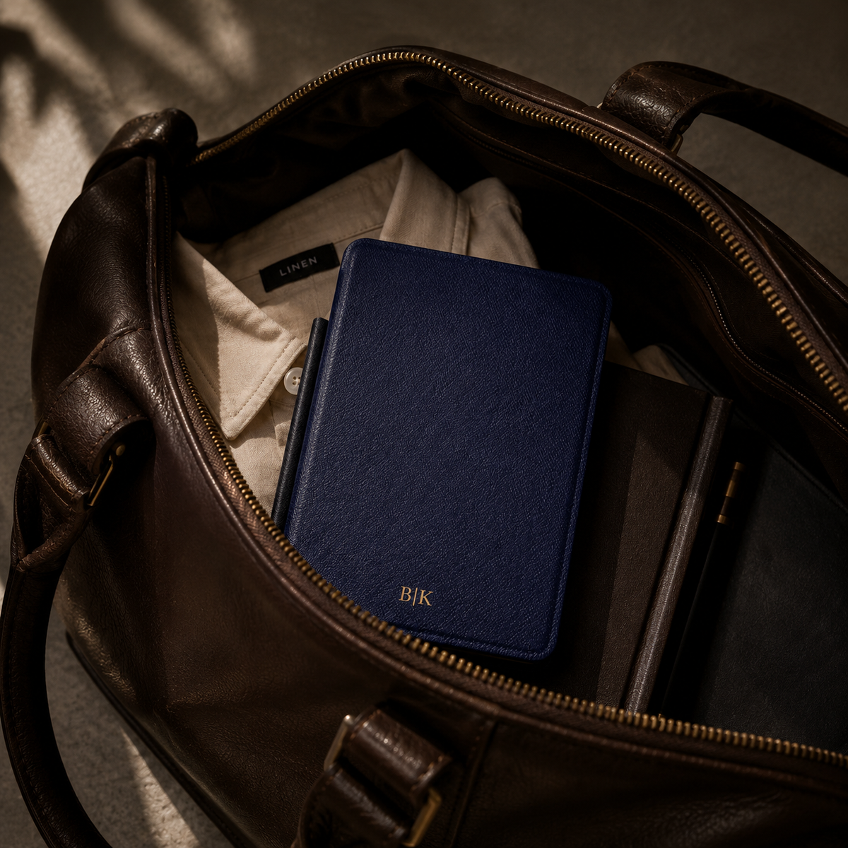 Open interior of the navy Saffiano Kindle case showing the fabric lining and TPU shell
