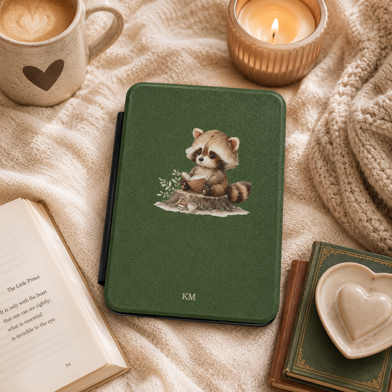 Personalized reading raccoon Kindle case styled in a lifestyle reading setting