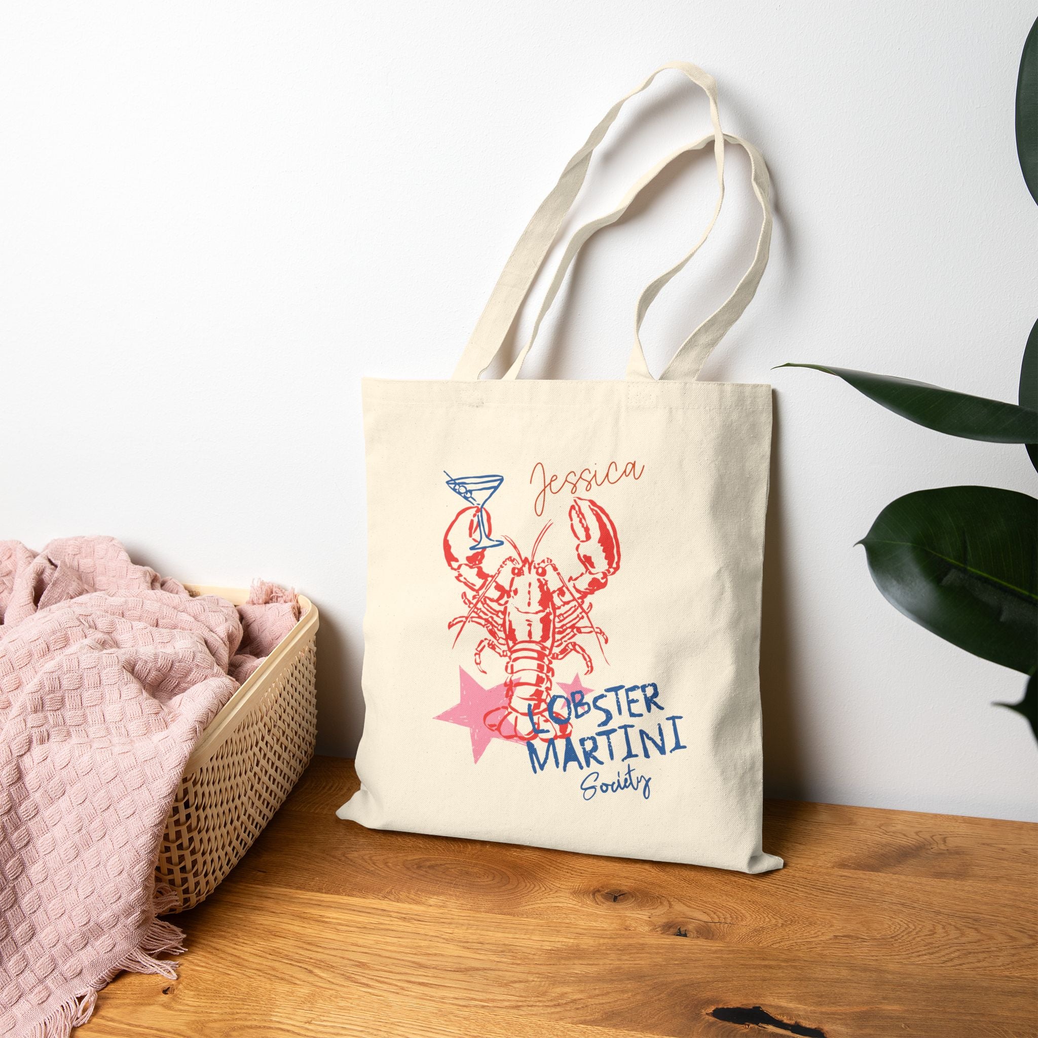 Close-up of lobster and martini print and custom name on canvas tote bag