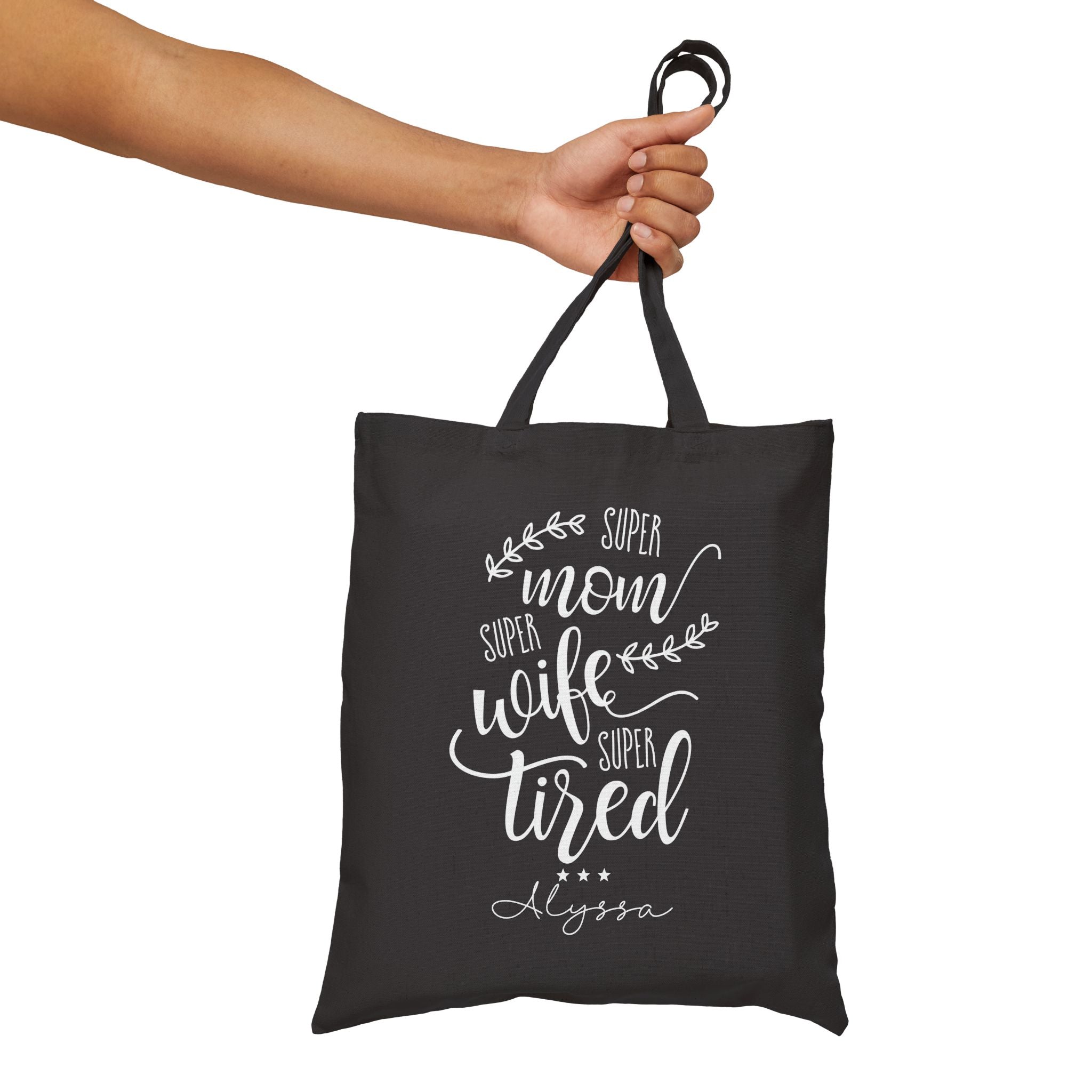 Close-up of Super Mom quote print and custom name on canvas tote bag