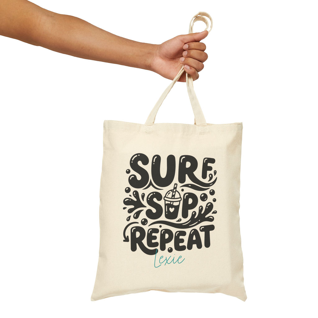 Personalized surf sip repeat canvas tote bag styled in a home setting