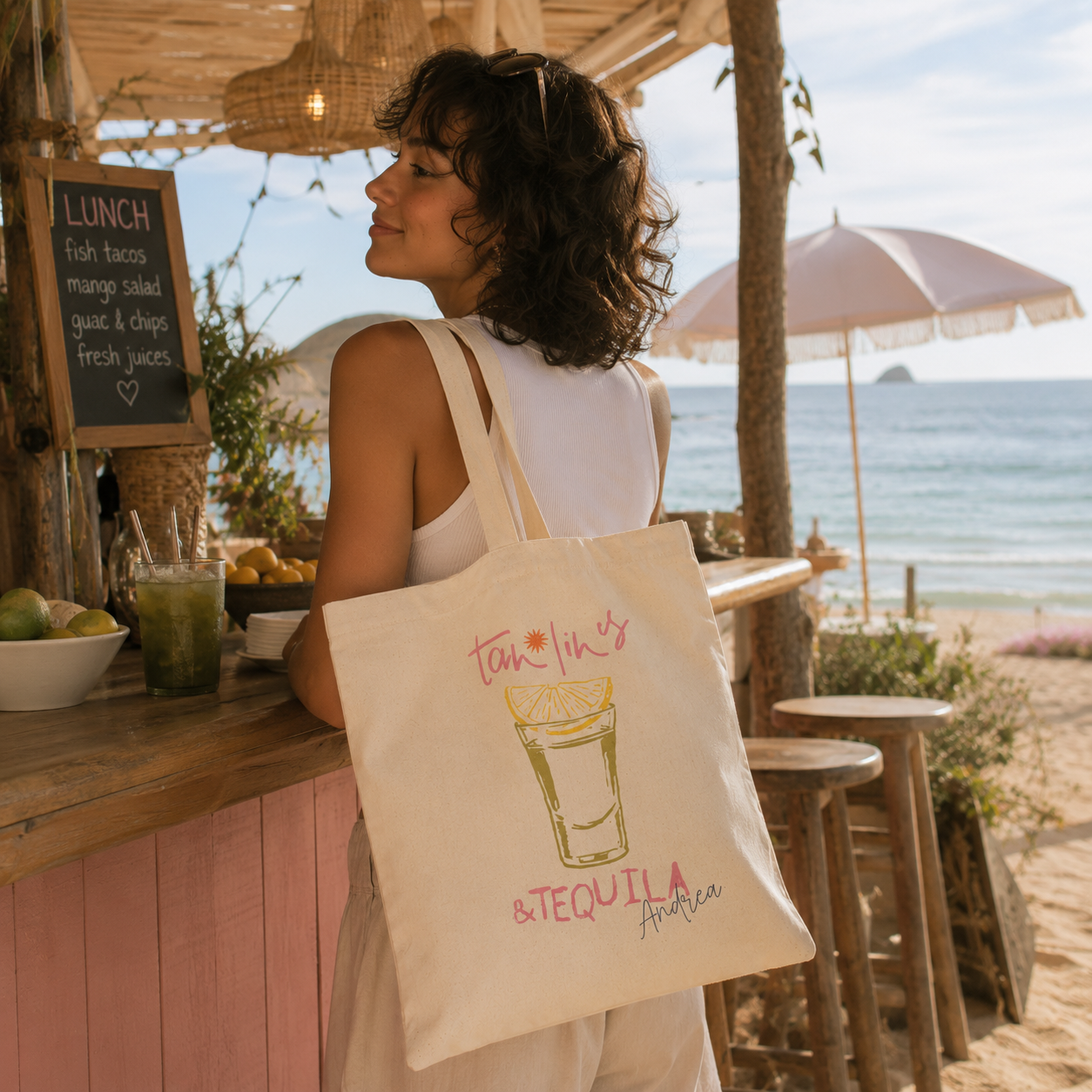 Personalized tan lines tequila tote bag shown worn on shoulder, lifestyle photo
